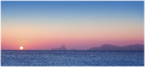 Pic: Sun setting into the sea, silhouetting Es Vedra